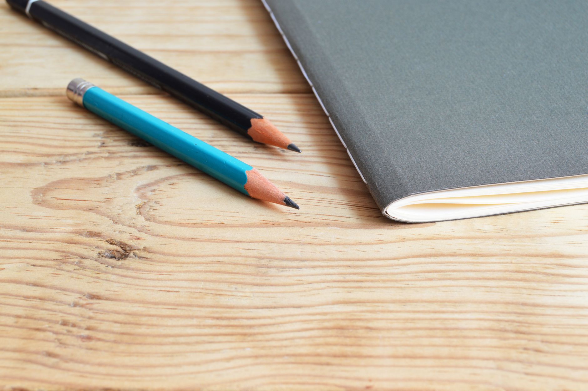 Notebook with game concept sketches on a desk beside a computer