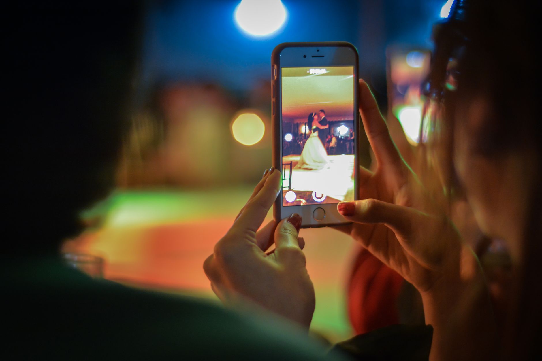 A person filming a dance-style gathering on a smartphone